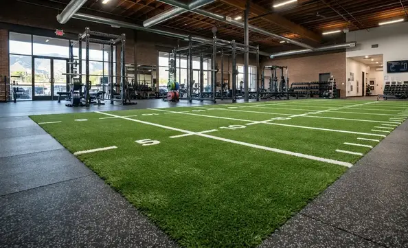 Professional gym turf installation inside a commercial fitness facility showing precision turf layout and premium athletic flooring