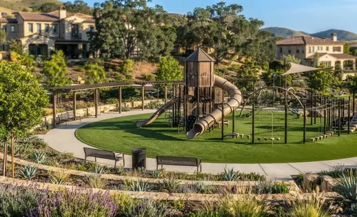 Commercial playground equipment installed over engineered artificial playground turf