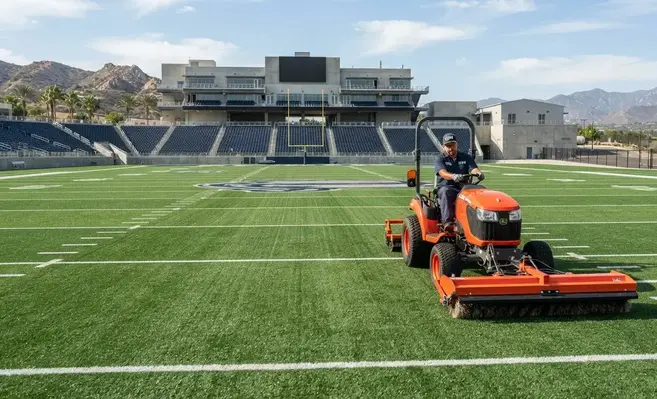 Professional maintenance service on an artificial sports turf athletic field